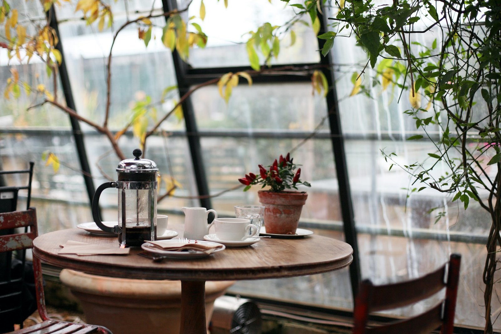 Latte and pour-over coffee on a table inside a Boise coffee shop with morning light through the window.